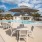 a pool with tables and chairs next to it