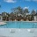 a swimming pool with a deck and chairs
