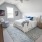 a bedroom with a bed and a chair