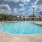 a swimming pool with a building in the background