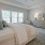 a bedroom with a bed and a fan