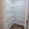 a white shelving unit in a closet