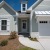 a grey house with a garage beaumont oaks at porters neck wilmington nc