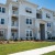 a white building with a lawn