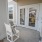 a couple white chairs outside a house